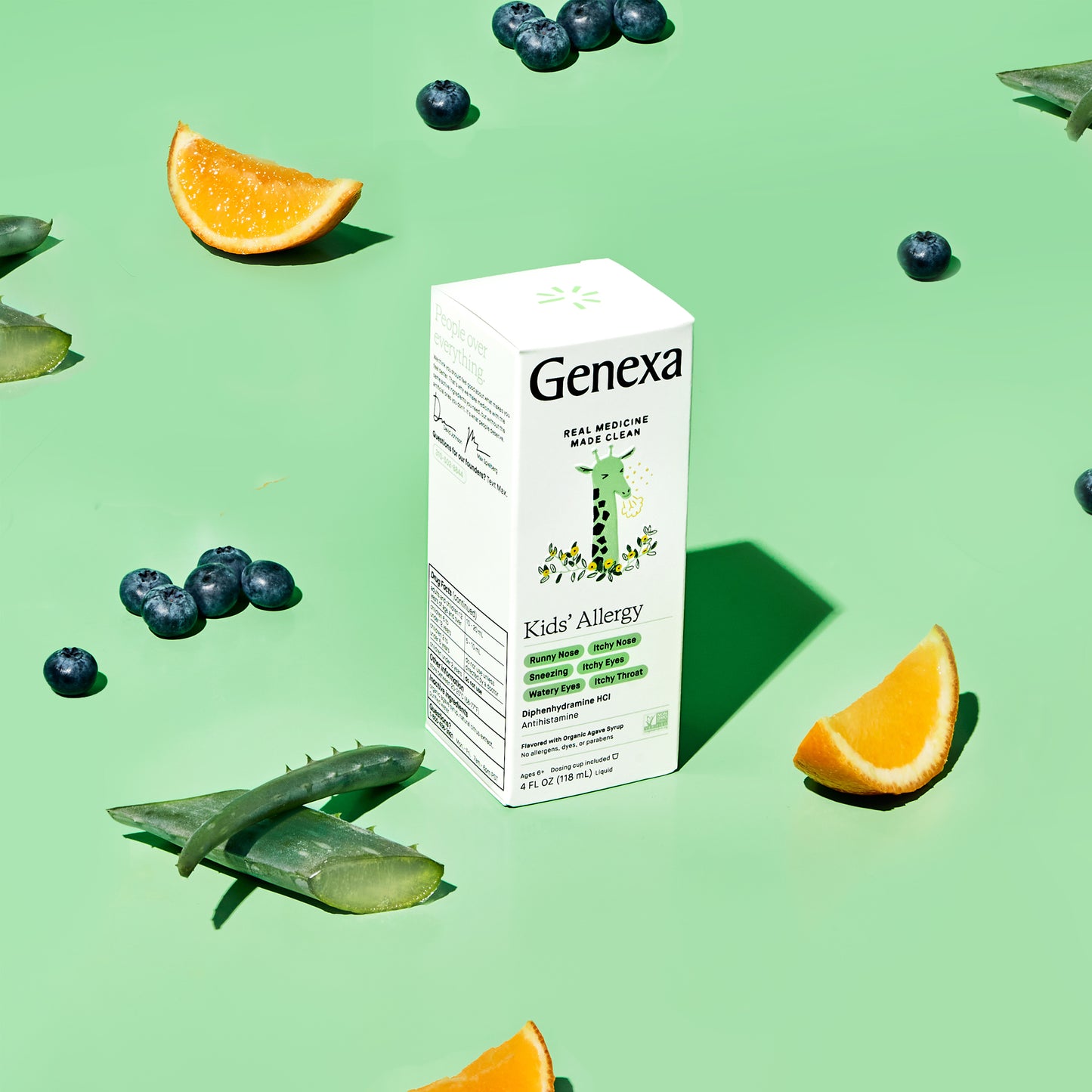 Genexa Kids' Allergy product box on a green background with aloe vera, oranges, and blueberries.