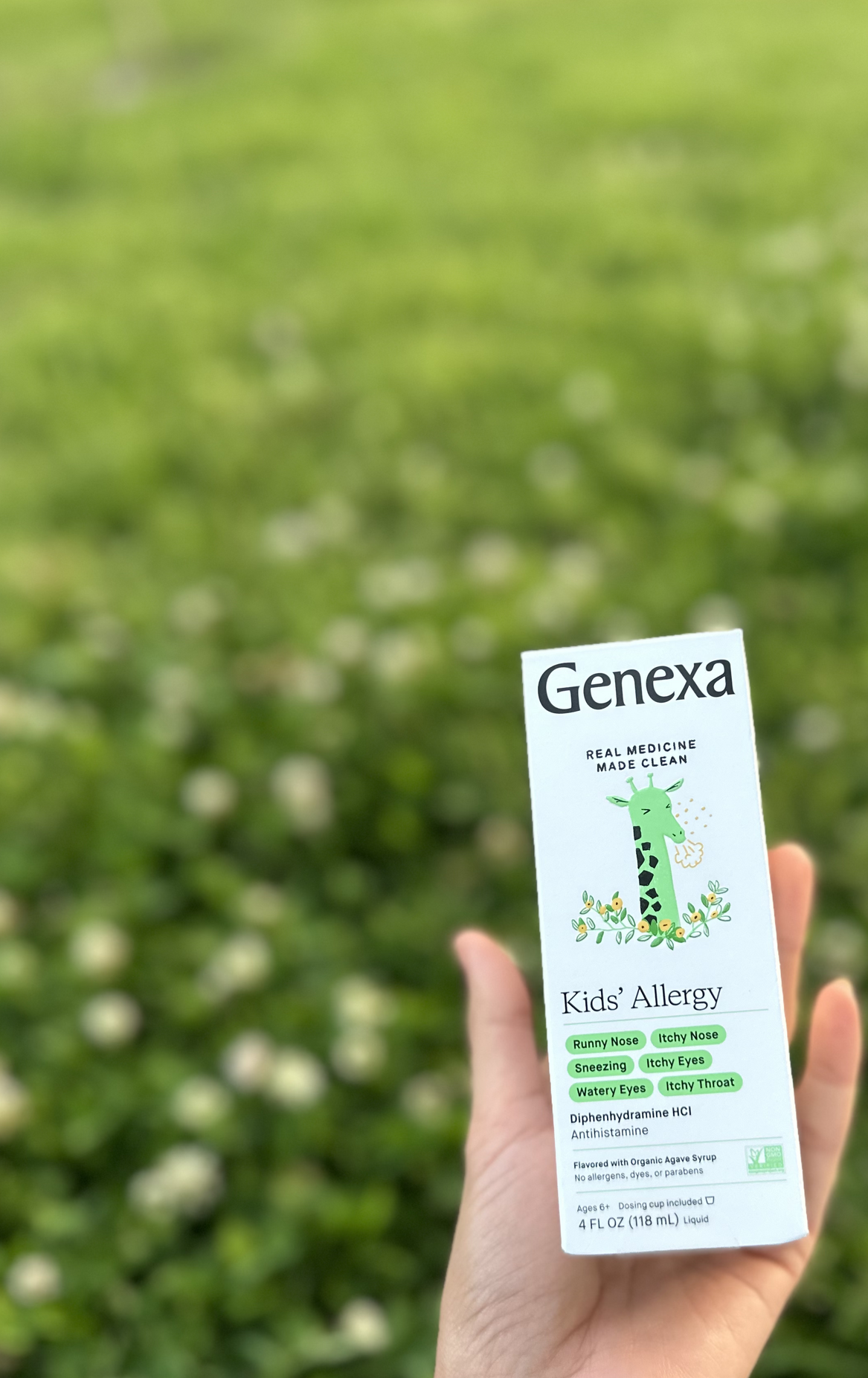 a bottle of Genexa kids allergy medicine in a field 